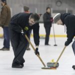 curlers sweeping ice