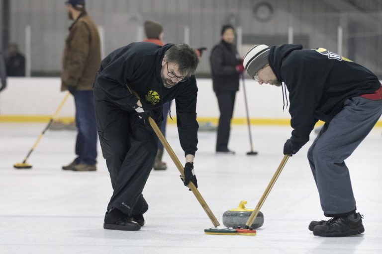 curlers sweeping ice