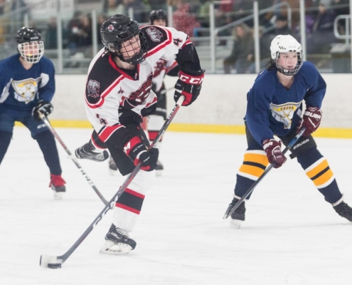 High school hockey player shooting