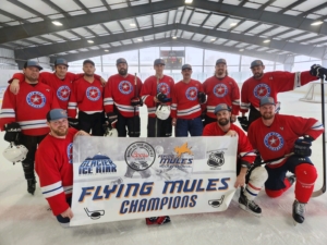 Men's hockey team posing with championship banner