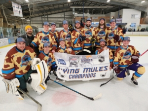 Men's hockey team posing with championship banner