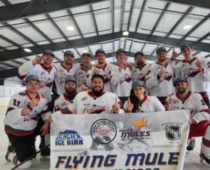 Men's hockey team posing with championship banner